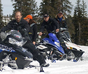 Brett Rasmussen, at left, welcomes all brands of snowmobilers to tap into his knowledge of powder riding.